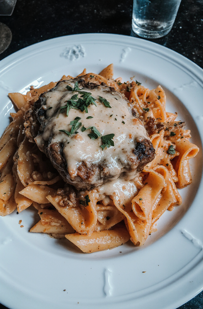 Cajun Steak with Parmesan Rigatoni | Amateur Close-Up from Reddit, Shot on iPhone 17 Pro Daytime Side Angle, Shot by Amateur, Mouthwatering and delicious homemade Cajun steak in creamy Parmesan rigatoni, featuring tender cuts of meat topped with a rich, velvety cheese sauce, served with slow-cooked rigatoni pasta and garnished with fresh parsley. --iw 3