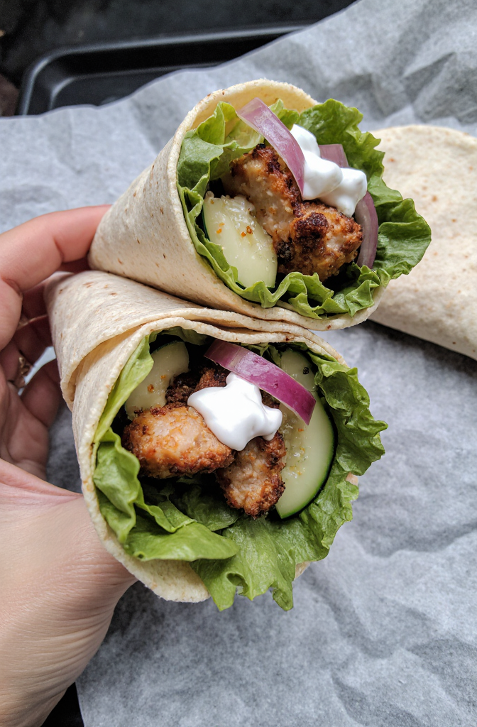 Sweet Chili Chicken Wraps | Amateur zoomed-in close-up from Reddit, taken on an iPhone 17 Pro during the day from a side angle. Shot by amateur, these homemade sweet chili chicken wraps are mouthwatering and delicious, filled with tender marinated chicken strips, fresh lettuce, crunchy cucumbers, and vibrant red onions, all wrapped in a soft flour tortilla and drizzled with creamy yogurt. --iw 3